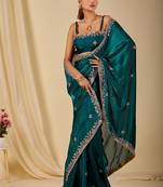 Teal ethnic motifs embroidered organza saree