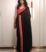 Black ethnic motifs embroidered satin saree