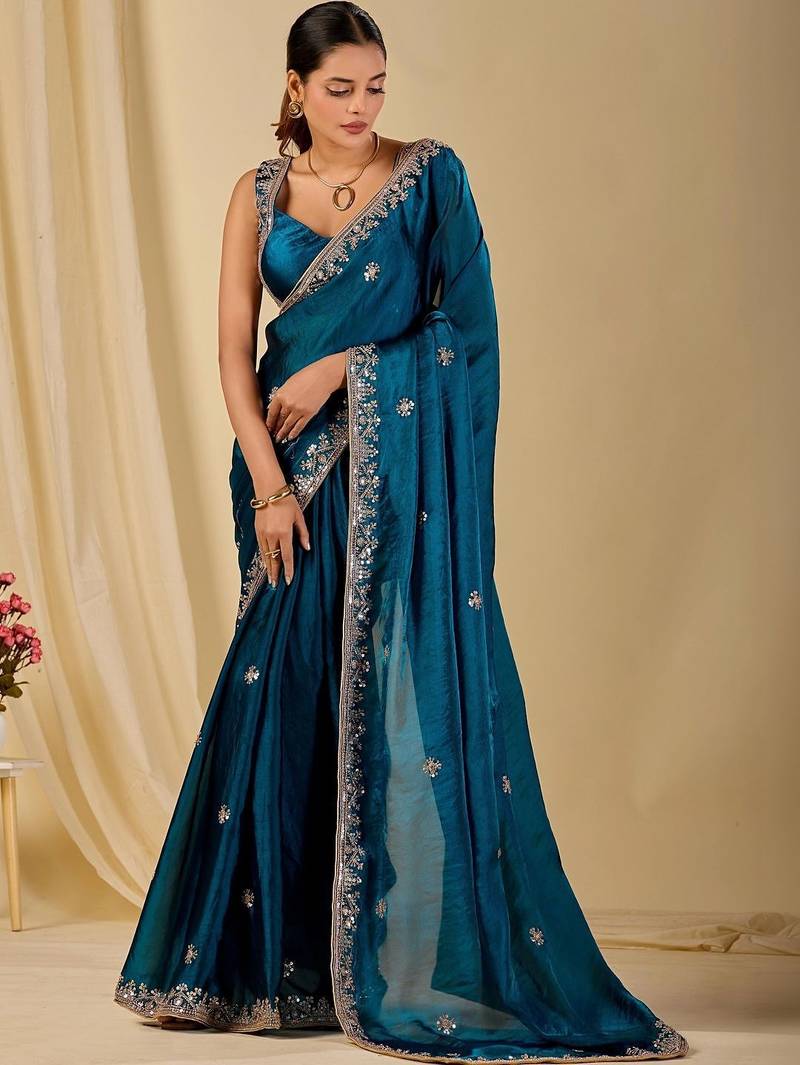 Teal ethnic motifs embroidered organza saree