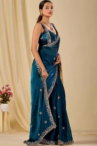 Teal ethnic motifs embroidered organza saree