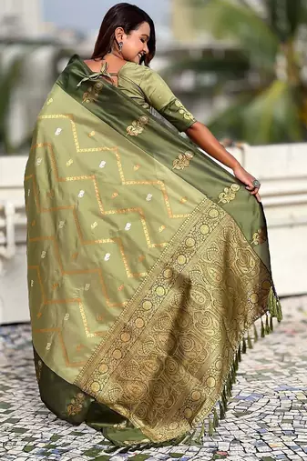 Green ethnic motifs woven design zari banarasi saree with tasseled