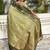 Green ethnic motifs woven design zari banarasi saree with tasseled