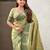 Green ethnic motifs woven design zari banarasi saree with tasseled