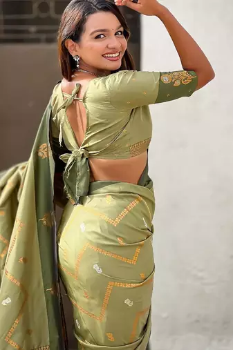 Green ethnic motifs woven design zari banarasi saree with tasseled