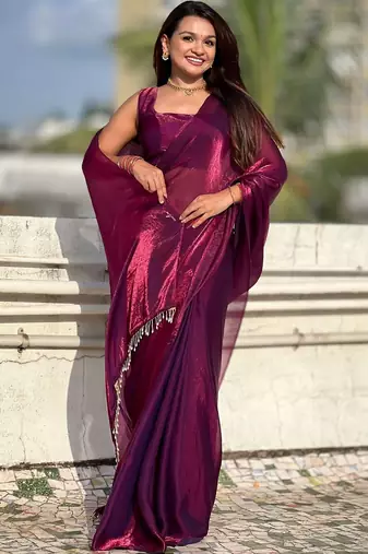 Purple shimmer satin tissue saree with golden tassels