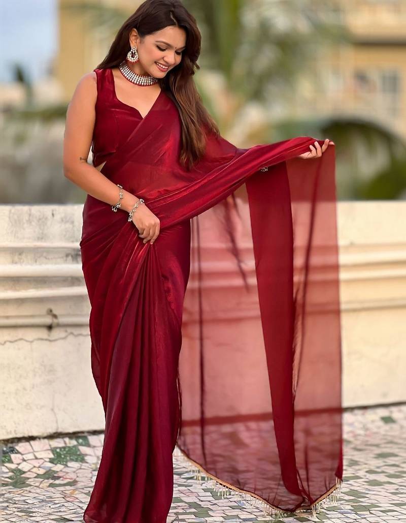 Maroon red shimmer satin tissue saree with golden tassels