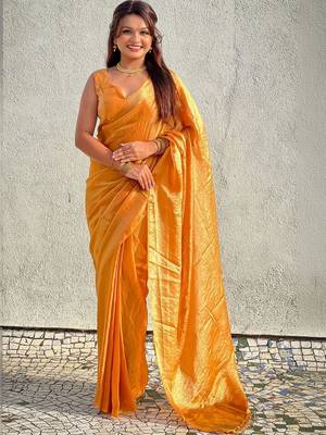 Mustard yellow shimmer satin tissue saree with golden tassels 1