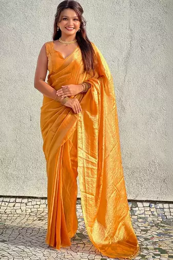 Mustard yellow shimmer satin tissue saree with golden tassels