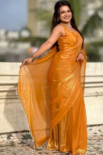 Mustard yellow shimmer satin tissue saree with golden tassels