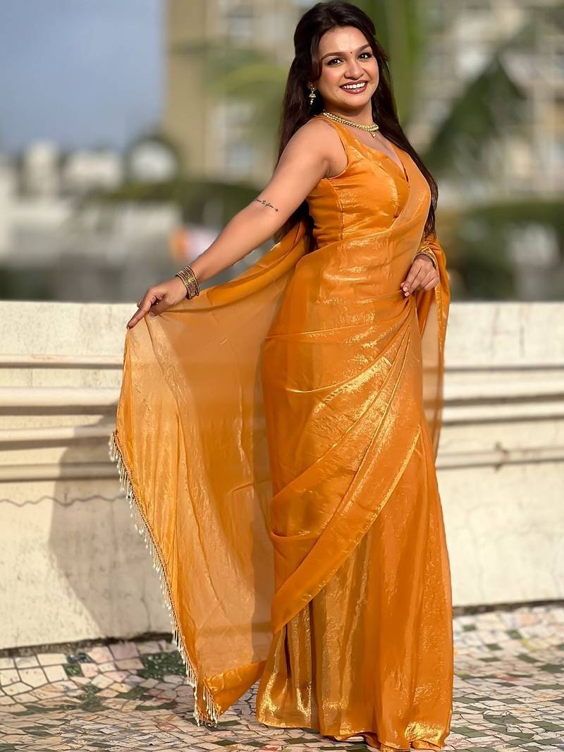 Mustard yellow shimmer satin tissue saree with golden tassels
