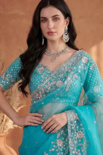 Turquoise embroidered organza saree