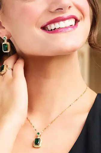 Gold plated cubic zirconia studded green pendant chain drop earrings