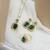 Gold plated cubic zirconia studded green pendant chain drop earrings