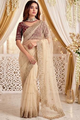 Cream embellished embroidered poly georgette heavy work saree