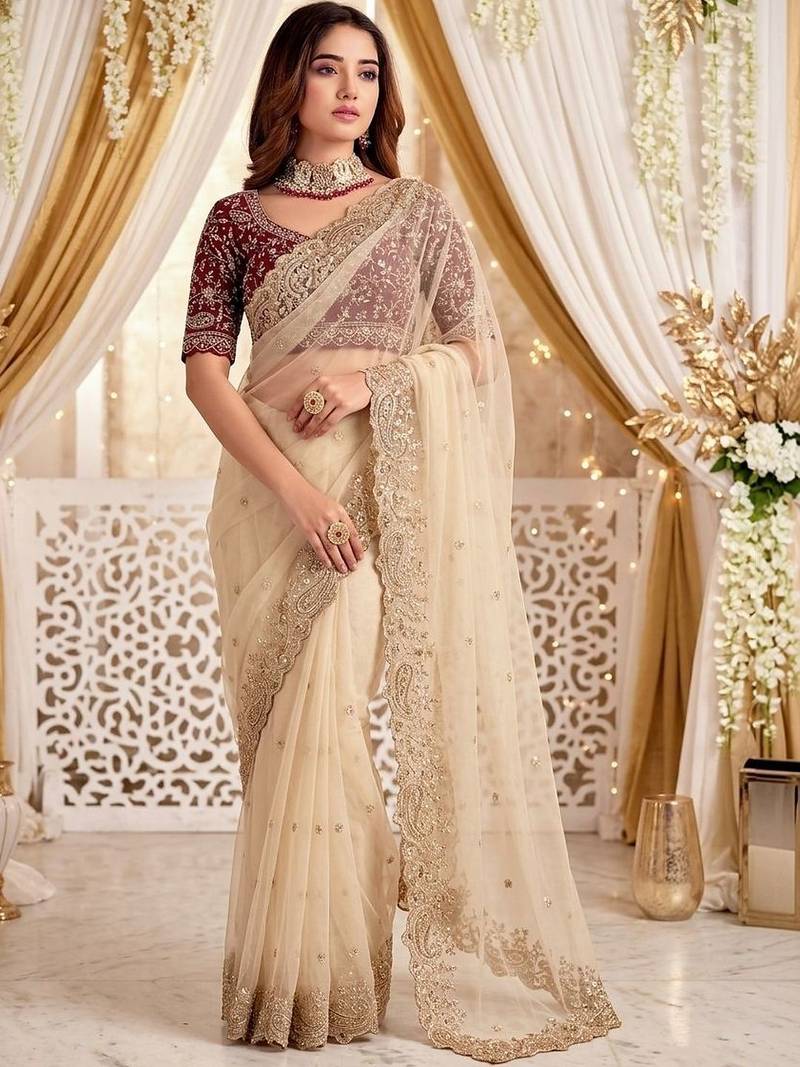 Cream embellished embroidered poly georgette heavy work saree