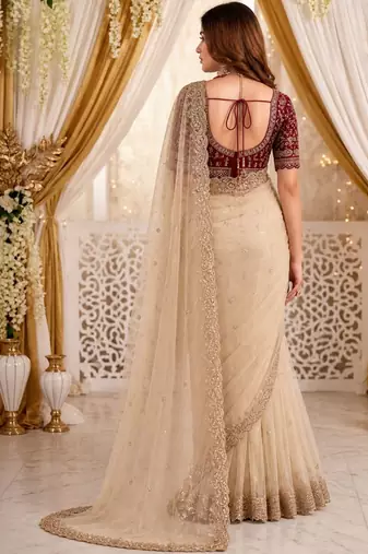 Cream embellished embroidered poly georgette heavy work saree