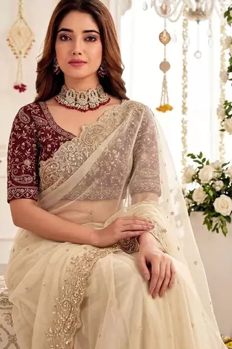 Cream embellished embroidered poly georgette heavy work saree
