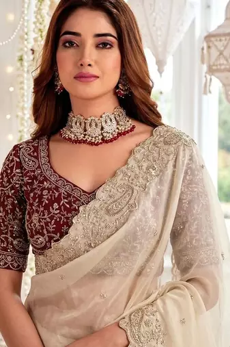 Cream embellished embroidered poly georgette heavy work saree