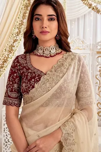 Cream embellished embroidered poly georgette heavy work saree