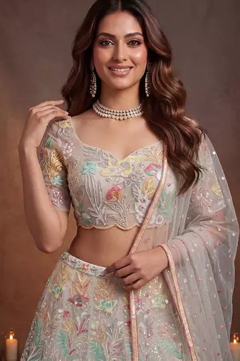 Bewitching White Thread and Multiple Sequins Embroidered Soft Net reception wear lehenga