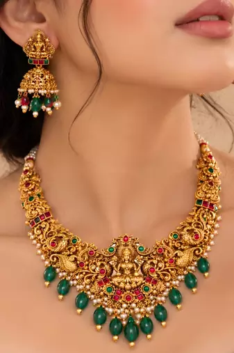 gold-plated temple necklace set with goddess lakshmi design and jhumka earrings