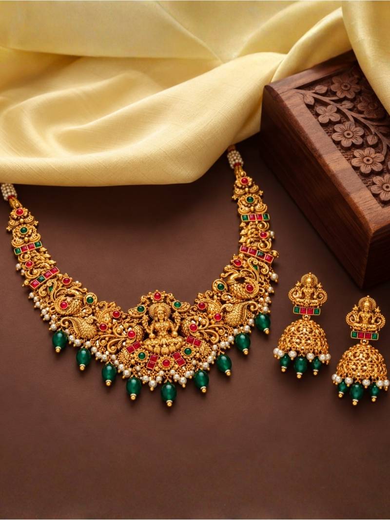 gold-plated temple necklace set with goddess lakshmi design and jhumka earrings