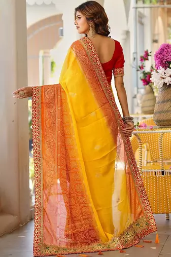 Yellow bandhani printed lace border sarees with contrast blouse piece