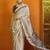 Cream ethnic motifs printed satin saree with blouse