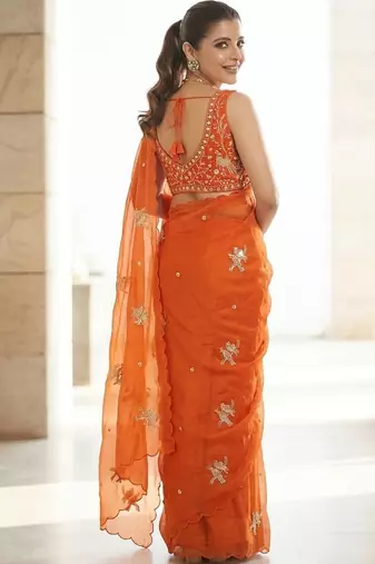 Orange ethnic motifs embroidered satin heavy work saree