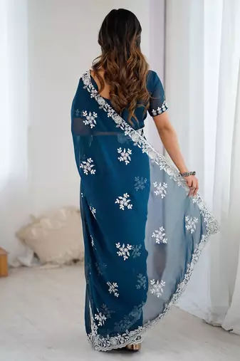 Teal embellished party wear saree with matching blouse