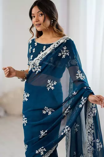 Teal embellished party wear saree with matching blouse