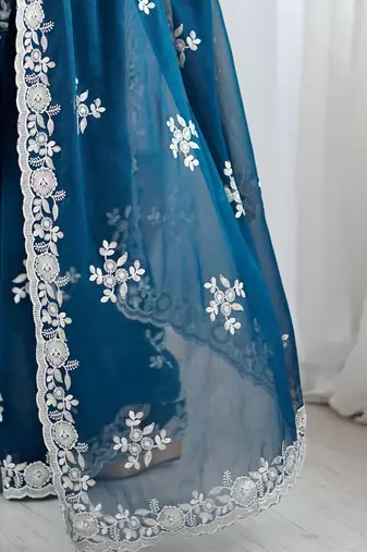 Teal embellished party wear saree with matching blouse