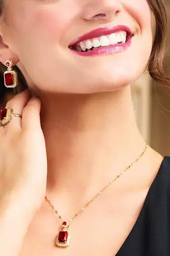 Gold plated red cubic zirconia studded pendant chain drop earrings