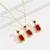 Gold plated red cubic zirconia studded pendant chain drop earrings