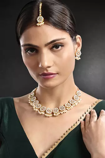Gold plated white kundan & beads studded necklace earrings