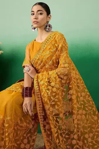 Mustard embroidered net saree with blouse piece