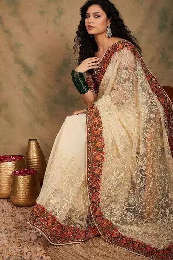 White ethnic motifs embroidered net saree