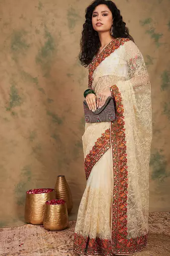 White ethnic motifs embroidered net saree