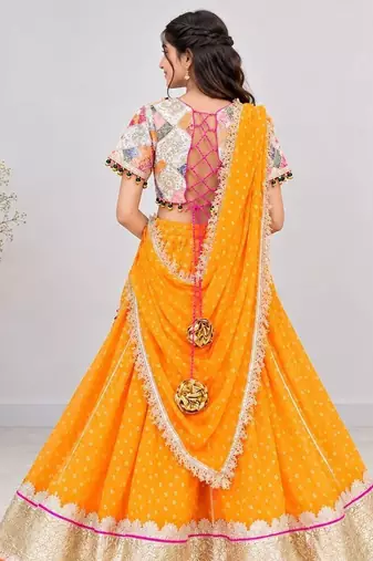 Off white embroidered choli with orange bandhej lehenga set