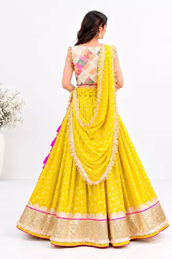 Off white embroidered choli with yellow bandhej lehenga set