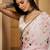 Off white abstract printed saree with embellished border & unstitched blouse