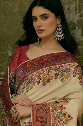 Off white position printed zari weaving saree with contrast blouse piece