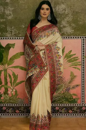 Off white position printed zari weaving saree with contrast blouse piece