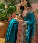 Teal position printed zari weaving saree with contrast blouse piece
