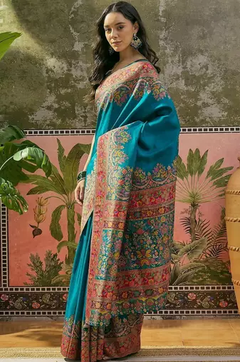 Teal position printed zari weaving saree with contrast blouse piece