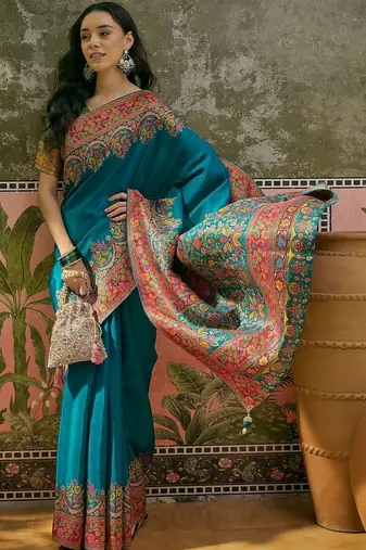 Teal position printed zari weaving saree with contrast blouse piece