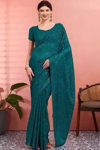 Teal ethnic embroidered festive wear saree with matching blouse