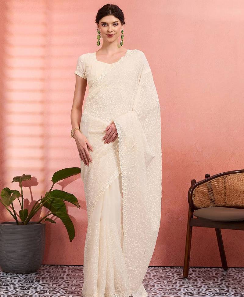 Off white ethnic embroidered festive wear saree with matching blouse