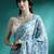 Turquoise geometric printed saree with blouse piece