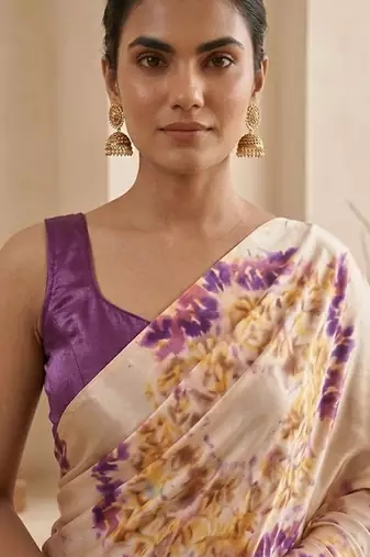 Cream women cream coloured purple floral printed pre draped saree